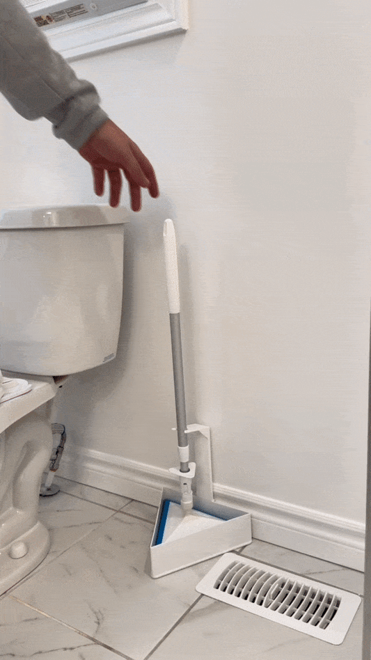 Pottymop cleaning a bathroom floor and ejecting dirty pad into trash
